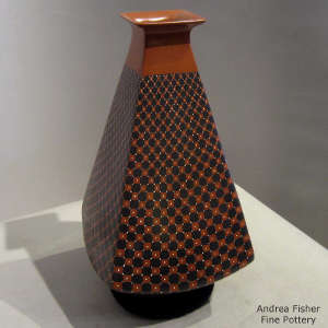 Square opening and geometric design on a pyramid jar