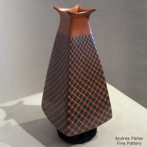 Geometric design on a polychrome pyramid jar with a flared square opening
