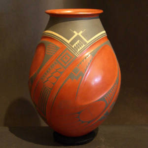 Paquime geometric designs decorate a lightly carved polychrome jar