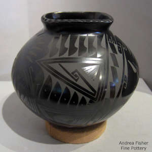 Square opening and geometric design on a black on black jar