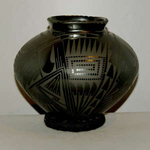 Geometric design on a black on black jar with a square opening