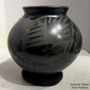 Geometric design on a black on black jar with a square opening