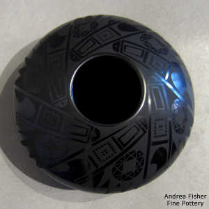 Shard and geometric design on a black on black jar