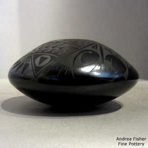 Bird element and geometric design on a black on black jar