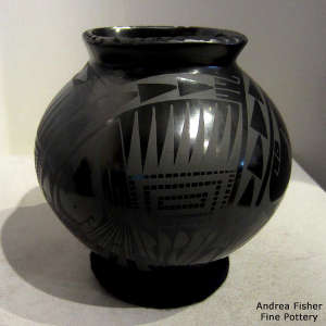 Geometric design on a black on black jar with a square opening
