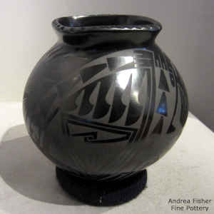 Black on black jar with a geometric design and square rim