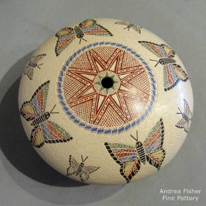 Sgraffito and painted butterfly and geometric design on a polychrome seedpot