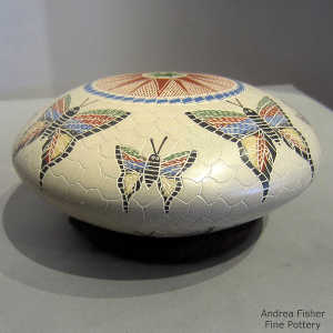 Sgraffito and painted butterfly, mesh and geometric design on a polychrome seed pot