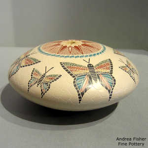 Sgraffito and painted butterfly and geometric design on a polychrome seed pot