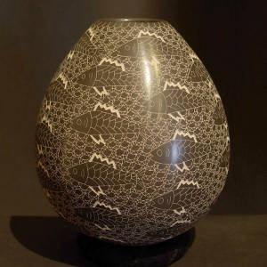Sgraffito fish and underwater scene on a black and white jar