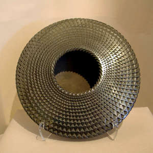 Textured surface on a black flying saucer jar