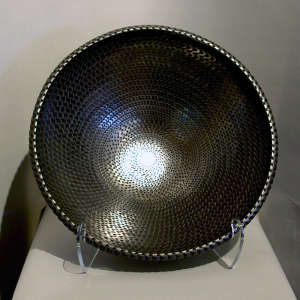 Corrugated surface on a large polished black bowl
