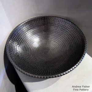 Corrugated surface inside and out on a polished black bowl