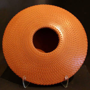 Corrugated surface on a red flying saucer jar