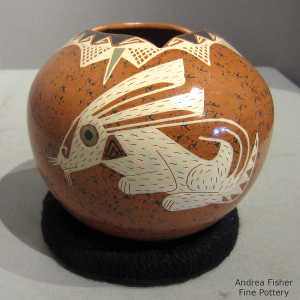 Rabbit and geometric design plus a geometric opening on a polychrome jar