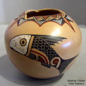 Sgraffito and painted fish and geometric design on a polychrome jar with a geometric cut opening