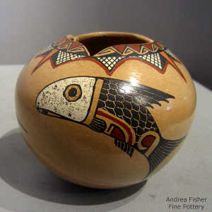 Fish and geometric design on a polychrome jar with a geometric cut opening