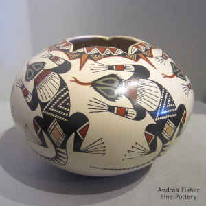 Polychrome jar with a lizard and geometric design plus a geometric cut opening