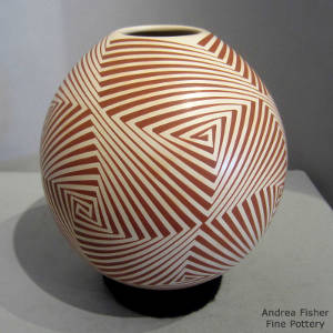 Geometric design decorating a red and cream jar