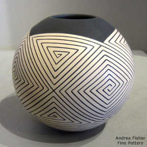 Spiral geometric design on a black on tan jar