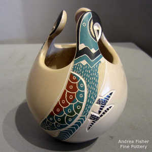 Sgraffito and painted parrot design on a lightly carved polychrome jar