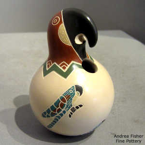 A sgraffito and painted parrot design on a polychrome parrot effigy jar