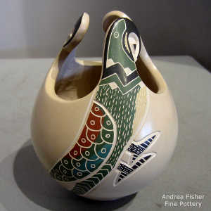 Sgraffito and painted parrot design on a polychrome jar with an organic opening