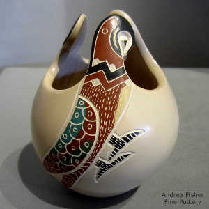 Lightly carved, sgraffito and painted parrot and geometric design on a polychrome parrot effigy