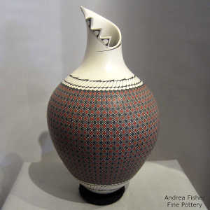 An organic opening and geometric design on a polychrome jar