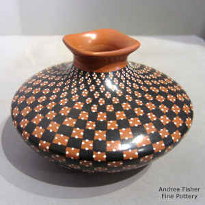 A flared square rim on a polychrome jar with a painted checkerboard and domino geometric design