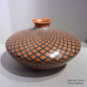 A squarish flared lip and cuadrillos geometric design on a polychrome jar