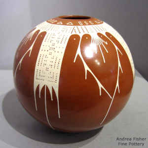 Sgraffito and painted geometric design on a red and white jar