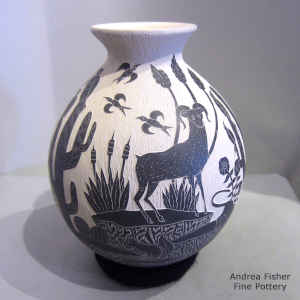 Sgraffito desert nature and wildlife design on a black and white jar