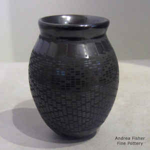A geometric design on a black on black jar