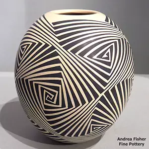 Black geometric design on a cream-colored jar
