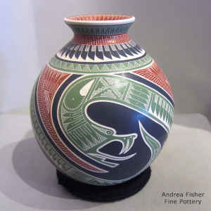 Lightly carved, sgraffito and painted serpent and geometric design on a polychrome jar