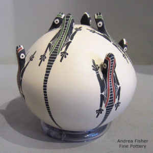 Applique, sgraffito and painted lizard design on a polychrome seed pot