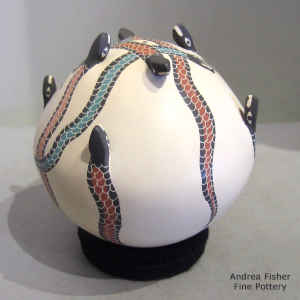 Polychrome seed pot decorated with a sgraffito, painted and applique serpent design