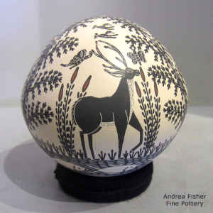 Sgraffito and painted deer, butterfly, bird, fish and nature design on a polychrome seed pot