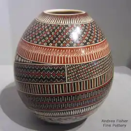 A sgraffito and painted macaw and Paquimé geometric design on a polychrome jar