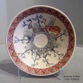 Sgraffito and painted wildlife and nature design on a polychrome bowl