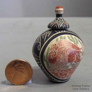 Miniature polychrome lidded jar with a sgraffito and painted bison and desert scene surrounded with a geometric design