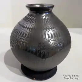 Black-on-black jar with a rolled lip and a geometric design
