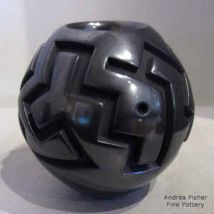 Polished black jar carved with a geometric design