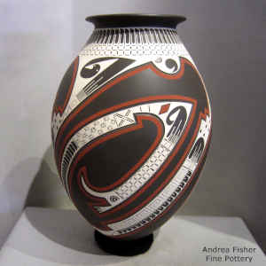 A lightly carved and painted geometric design on a polychrome jar