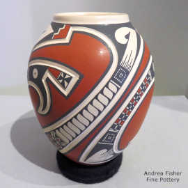 A lightly carved and painted geometric design on a polychrome jar