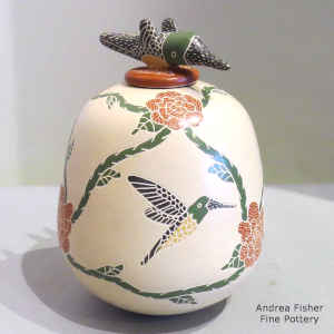 Sgraffito and painted hummingbird, flower and branch design on a polychrome jar with a hummingbird lid