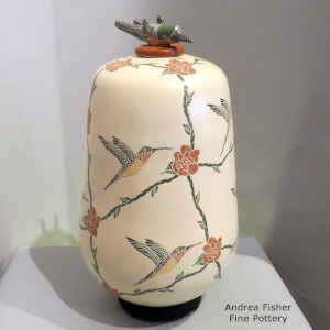 Sgraffito and painted hummingbird, flower and branch design on a polychrome jar with a hummingbird lid