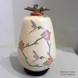 Sgraffito and painted hummingbird, flower and branch design on a polychrome jar with a hummingbird lid