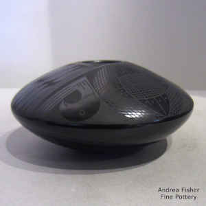 Bird and geometric design on a black on black jar